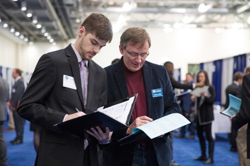 Professor David Lange and a student discuss resumes at the Career Fair